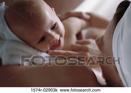Stock Image - Close-up of a mother holding her baby boy. Fotosearch