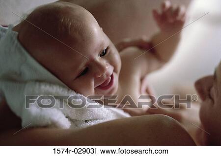 Close-up of a mother holding her baby boy View Large Photo Image Stock Image - Close-up of a mother holding her baby boy. Fotosearch