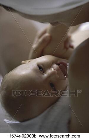 Close-up of a mother playing with her baby boy View Large Photo Image Stock Image - Close-up of a mother playing with her baby boy. Fotosearch