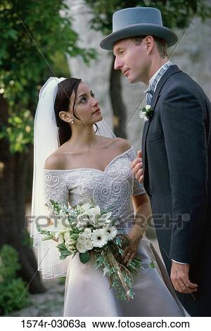 Close-up of a newlywed couple standing together View Large Photo Image Stock Image - Close-up of a newlywed couple standing together. Fotosearch