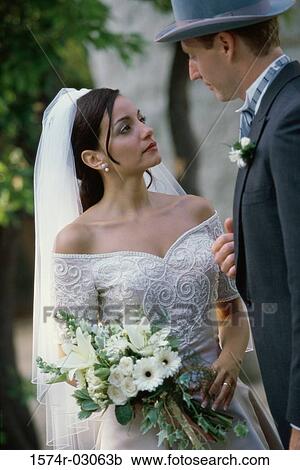 Stock Image - Close-up of a newlywed couple standing together. Fotosearch