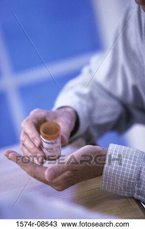 Close-up of a person holding a bottle of pills View Large Photo Image Stock Image - Close-up of a person holding a bottle of pills. Fotosearch