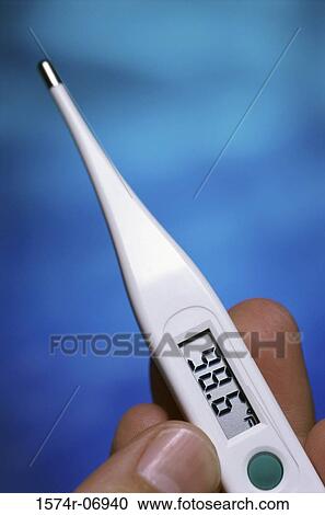 Close-up of a person holding a digital thermometer View Large Photo Image Stock Image - Close-up of a person holding a digital thermometer. Fotosearch