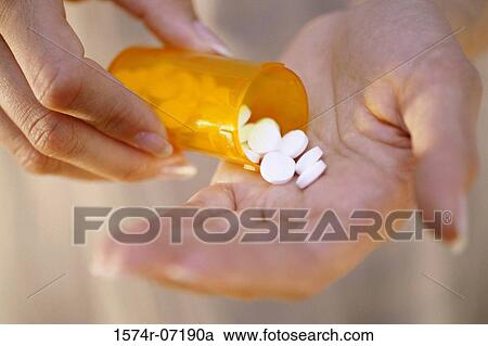 Close-up of a person's hand holding a bottle of pills View Large Photo Image Stock Image - Close-up of a person's hand holding a bottle of pills. Fotosearch
