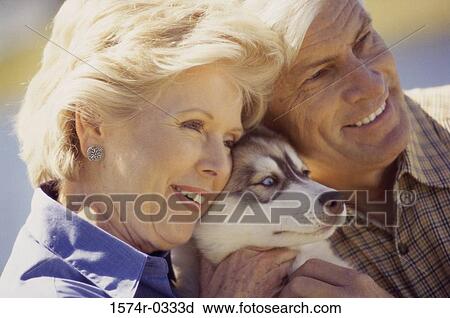Close-up of a senior couple with their dog View Large Photo Image Stock Image - Close-up of a senior couple with their dog. Fotosearch