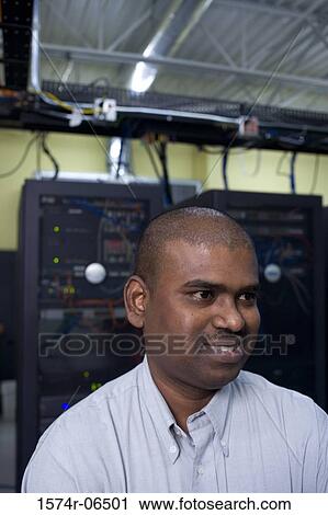 Stock Image - Close-up of a technician in a server room. Fotosearch