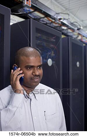 Close-up of a technician talking on a mobile phone View Large Photo Image Stock Image - Close-up of a technician talking on a mobile phone. Fotosearch