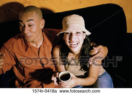Stock Image - Close-up of a young couple laughing. Fotosearch