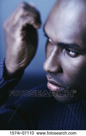Close-up of a young man with his hand near his face View Large Photo Image Stock Image - Close-up of a young man with his hand near his face. Fotosearch