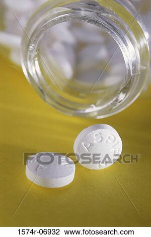 Stock Image - Close-up of an open bottle of aspirin tablets. Fotosearch