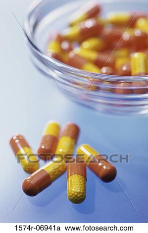 Close-up of capsules and a bowl View Large Photo Image Stock Image - Close-up of capsules and a bowl. Fotosearch