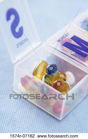 Close-up of capsules and tablets in a pill box View Large Photo Image Stock Image - Close-up of capsules and tablets in a pill box. Fotosearch