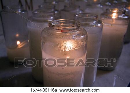 Close-up of lit candles in a church View Large Photo Image Stock Image - Close-up of lit candles in a church. Fotosearch