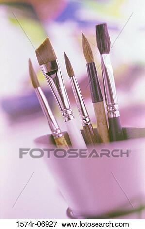 Stock Photo - Close-up of paintbrushes in a container. Fotosearch