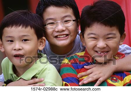 Stock Image - Close-up of three boys smiling. Fotosearch