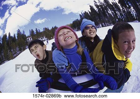 Close-up of two boys and two girls riding on a sled View Large Photo Image Stock Image - Close-up of two boys and two girls riding on a sled. Fotosearch