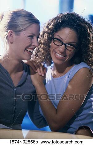Stock Image - Close-up of two young women smiling. Fotosearch