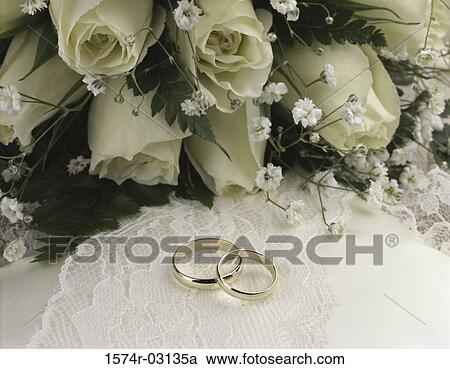 Close-up of wedding rings with a bouquet of flowers View Large Photo Image Stock Image - Close-up of wedding rings with a bouquet of flowers. Fotosearch