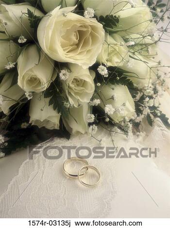 Close-up of wedding rings with a bouquet of flowers View Large Photo Image Stock Image - Close-up of wedding rings with a bouquet of flowers. Fotosearch