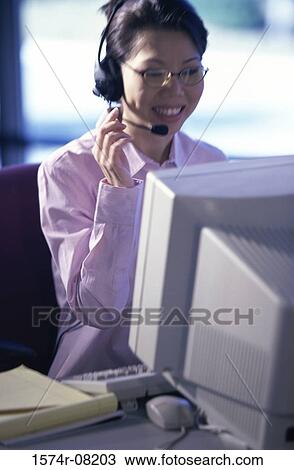 Stock Image - Customer service representative talking on a headset. Fotosearch