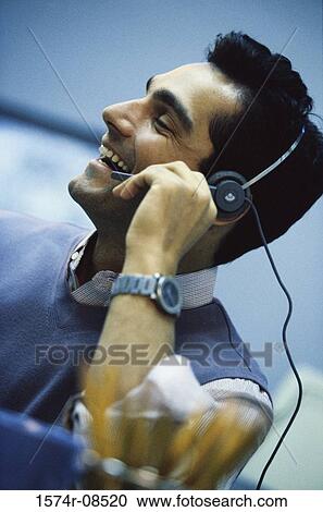 Stock Image - Customer service representative talking on a headset. Fotosearch