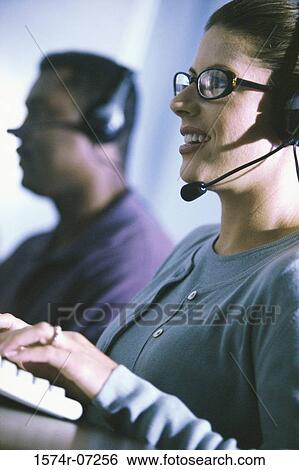 Stock Photograph - Customer service representative wearing a headset. Fotosearch