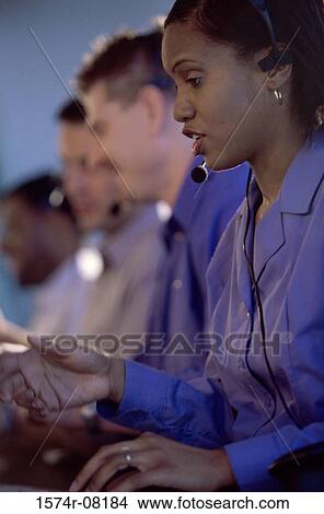 Picture - Customer service representatives sitting in a row. Fotosearch