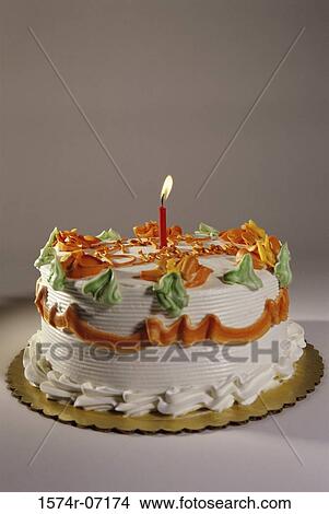 Decorated birthday cake with a lit candle View Large Photo Image Picture - Decorated birthday cake with a lit candle. Fotosearch