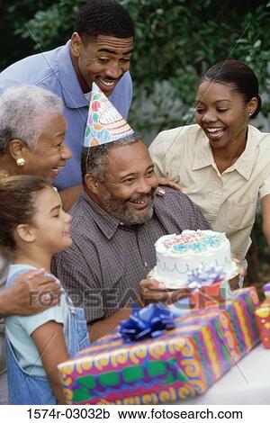 Stock Image - Family at a birthday party. Fotosearch