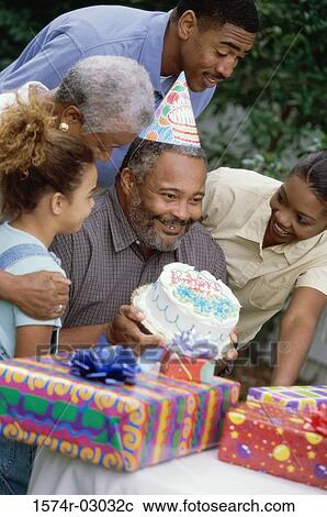Stock Image - Family at a birthday party. Fotosearch