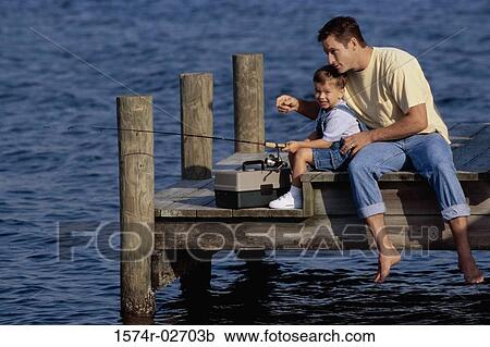 Father and his son sitting on a pier fishing View Large Photo Image Stock Image - Father and his son sitting on a pier fishing. Fotosearch