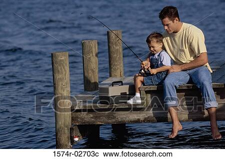 Stock Image - Father and his son sitting on a pier fishing. Fotosearch