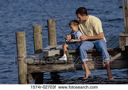 Father and his son sitting on a pier fishing View Large Photo Image Stock Image - Father and his son sitting on a pier fishing. Fotosearch