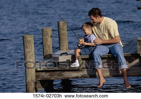 Father and his son sitting on a pier fishing View Large Photo Image Stock Image - Father and his son sitting on a pier fishing. Fotosearch