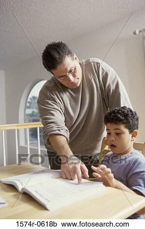 Father helping his son with homework View Large Photo Image Stock Image - Father helping his son with homework. Fotosearch