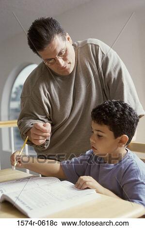 Father helping his son with homework View Large Photo Image Stock Image - Father helping his son with homework. Fotosearch