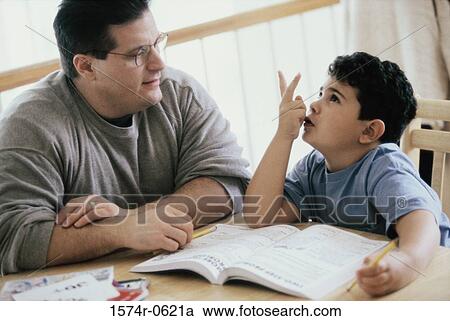 Father helping his son with homework View Large Photo Image Stock Image - Father helping his son with homework. Fotosearch