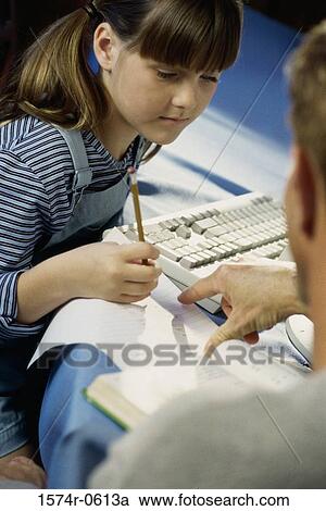 Stock Image - Father teaching his daughter. Fotosearch