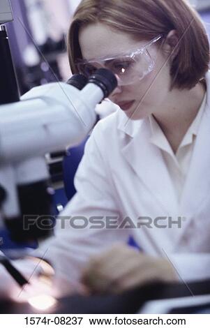 Female researcher working with a microscope View Large Photo Image Stock Photo - Female researcher working with a microscope. Fotosearch