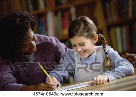 Female teacher teaching a girl View Large Photo Image Stock Image - Female teacher teaching a girl. Fotosearch