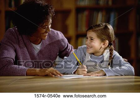 Female teacher teaching a girl View Large Photo Image Stock Image - Female teacher teaching a girl. Fotosearch
