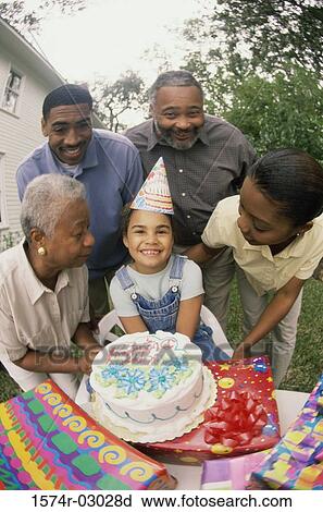 Girl celebrating her birthday with her parents and grandparents View Large Photo Image Stock Image - Girl celebrating her birthday with her parents and grandparents. Fotosearch