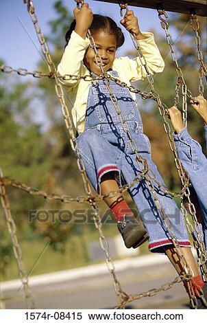 Girl climbing on a jungle gym View Large Photo Image Stock Photography - Girl climbing on a jungle gym. Fotosearch