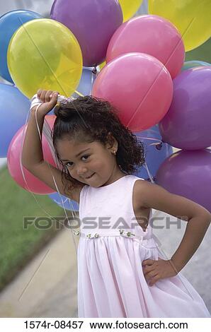 Girl holding balloons View Large Photo Image Stock Photo - Girl holding balloons. Fotosearch