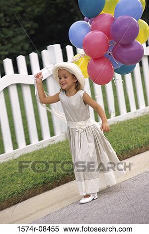 Girl holding balloons View Large Photo Image Stock Photography - Girl holding balloons. Fotosearch