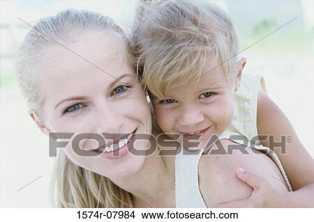 Picture - Girl riding piggyback on her mother. Fotosearch