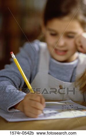 Girl writing on paper with a pencil View Large Photo Image Stock Image - Girl writing on paper with a pencil. Fotosearch