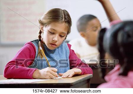 Girl writing on paper with a pencil View Large Photo Image Stock Photo - Girl writing on paper with a pencil. Fotosearch