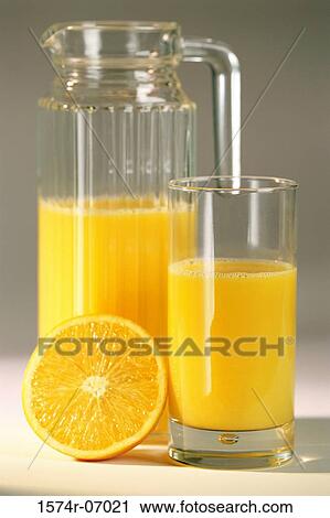 Glass and jug of orange juice and a sliced orange View Large Photo Image Stock Image - Glass and jug of orange juice and a sliced orange. Fotosearch