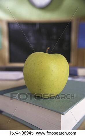 Granny Smith apple on a book View Large Photo Image Stock Photography - Granny Smith apple on a book. Fotosearch